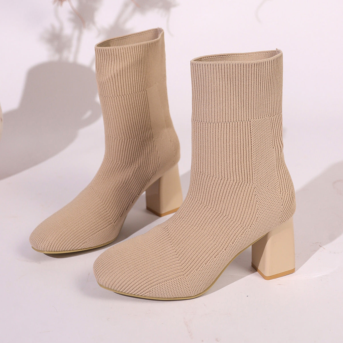 Knitted Round-Toe Sock Boots — High Heel Booties Women in beige color with sleek, stretch-fit design and block heels on display.
