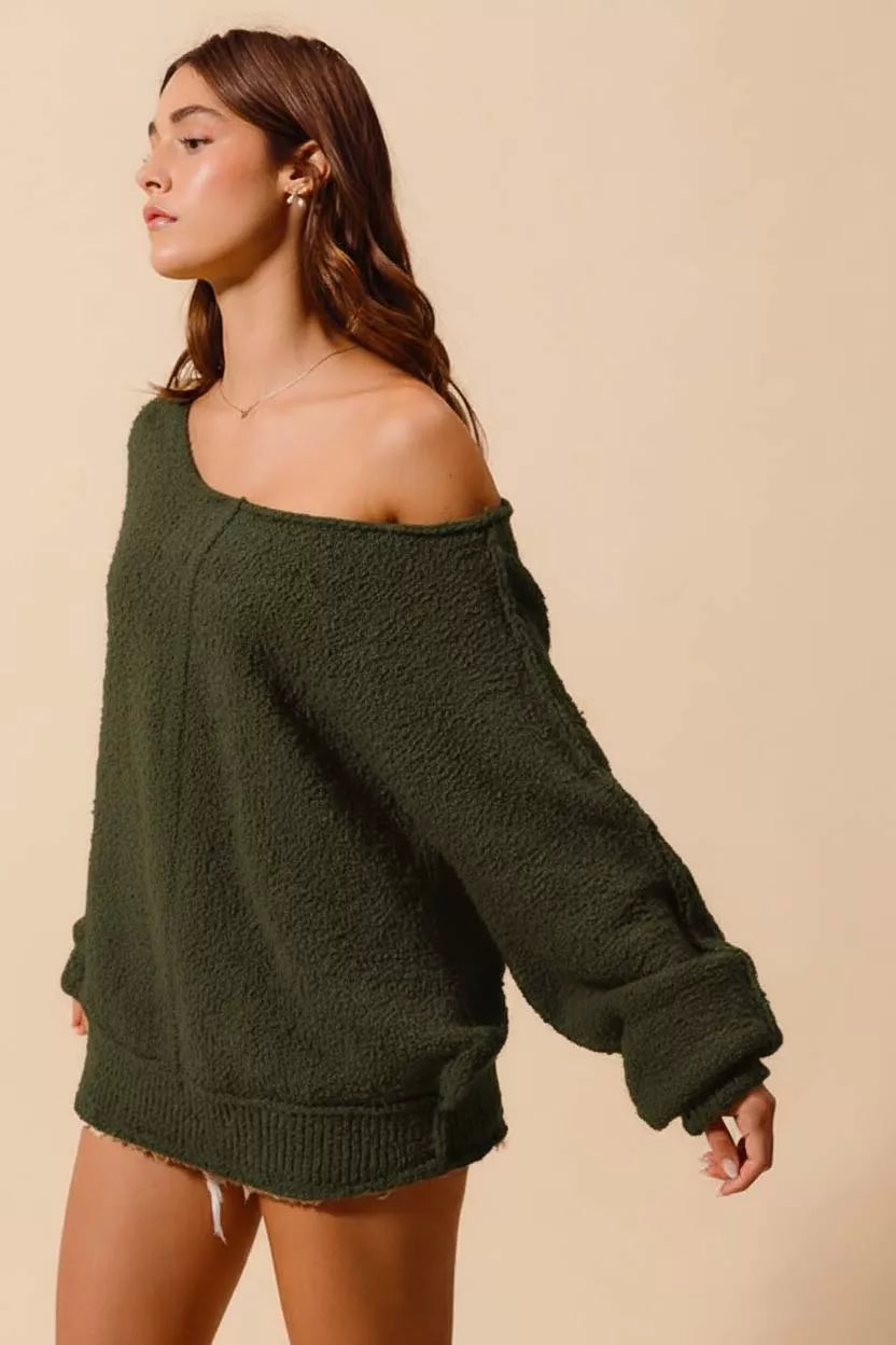 Woman wearing SO ME Loose Fit Exposed Seam Slouchy Boucle Sweater in green, showcasing slouchy style and exposed seam details.