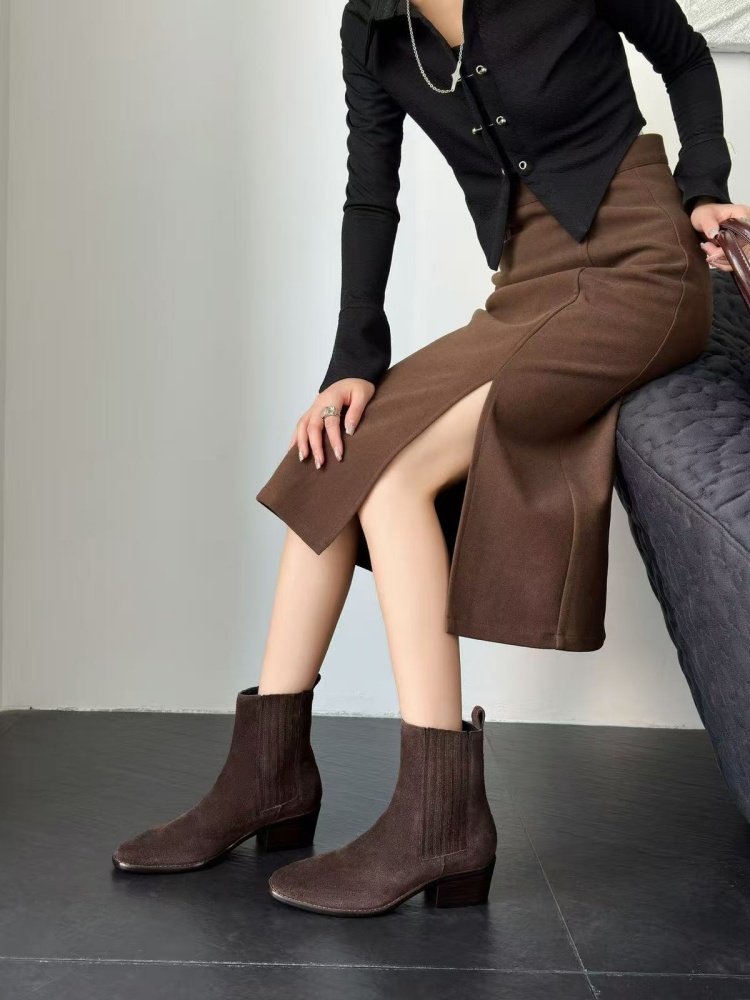 Woman wearing Women's Retro Square-Toe Mid-Heel Chunky Leather Boots with a brown skirt and black top.