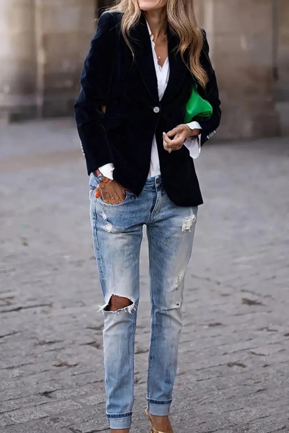 Woman wearing One-Button Lapel Collar Long Sleeve Blazer for Women with ripped jeans, holding a green clutch.