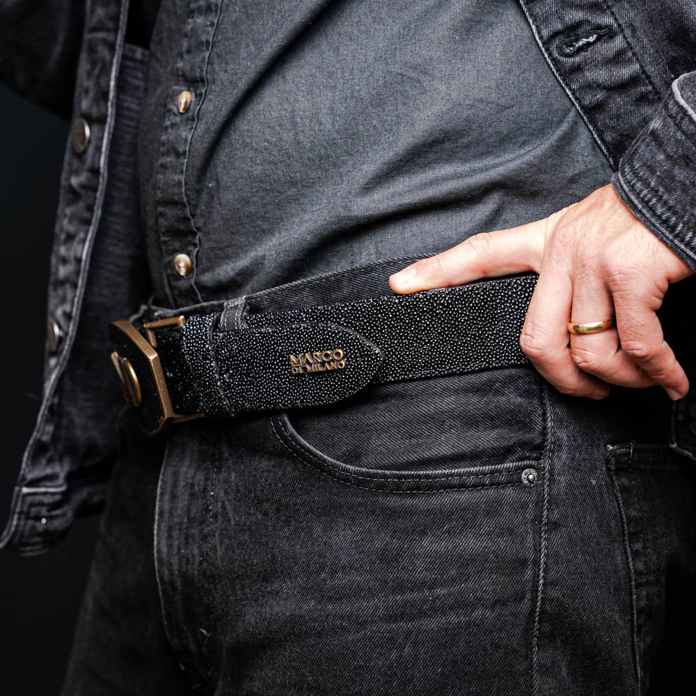 Man wearing Georgia Belt Black made from genuine stingray skin with diamond eye detail, showcasing exotic texture and craftsmanship.