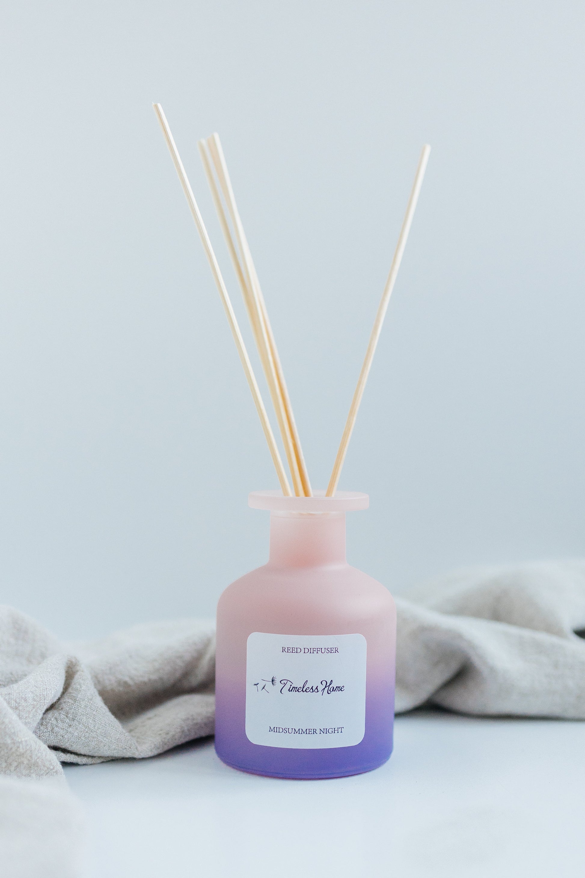 Reed Diffuser - Midsummer Night in custom frosted glass with natural reeds, 120mL, featuring fragrance notes of orange, jasmine, and musk.