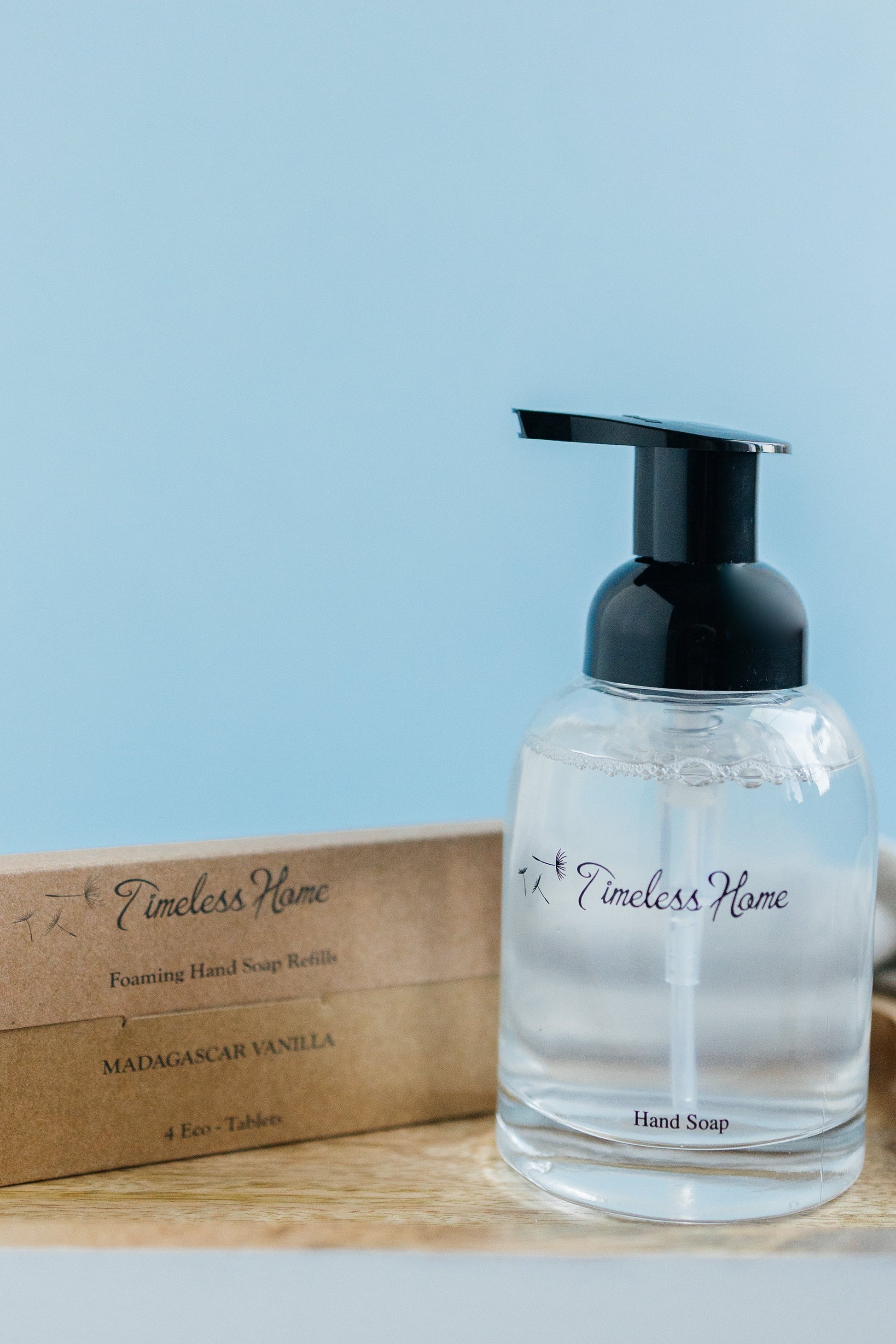 Eco Tab - Hand Soap Refill Pack beside a Timeless Home dispenser