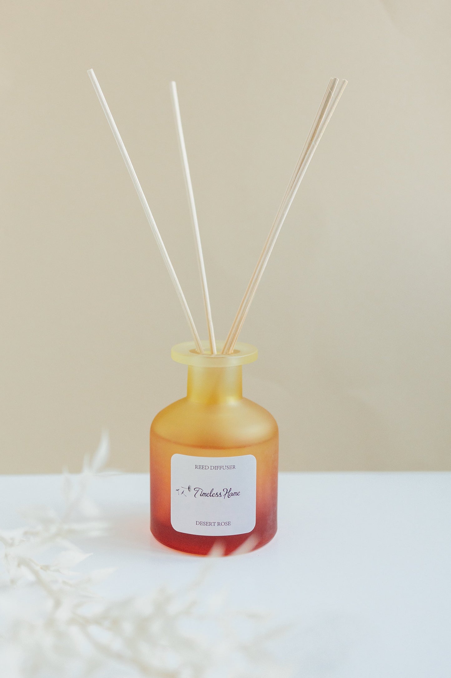Reed Diffuser - Desert Rose in frosted glass vessel with all-natural reed sticks, luxurious fragrance with rose, geranium, patchouli notes.