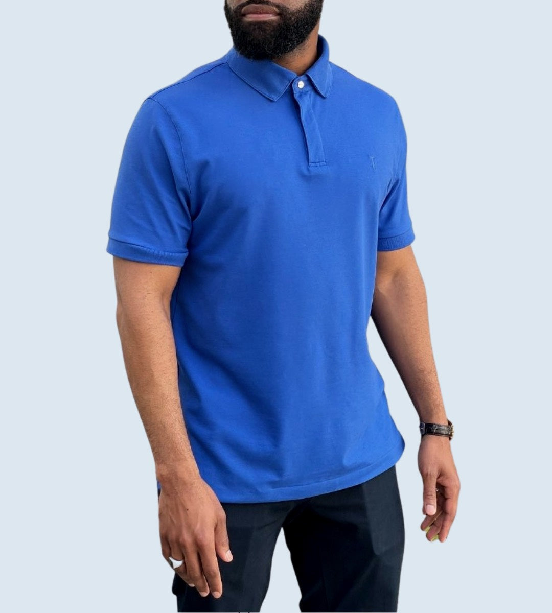 Man wearing a blue Short Sleeve Perfect Polo with StaySharp Collar and comfortable modern fit, demonstrating stylish wardrobe innovation.