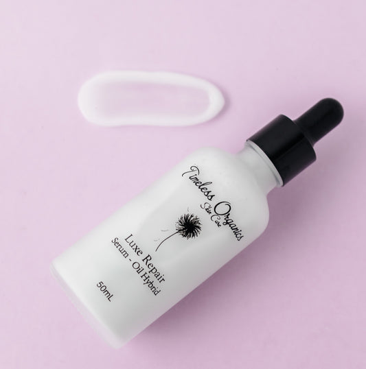 Luxe Repair Serum-Oil Hybrid bottle on pink background, 50mL size