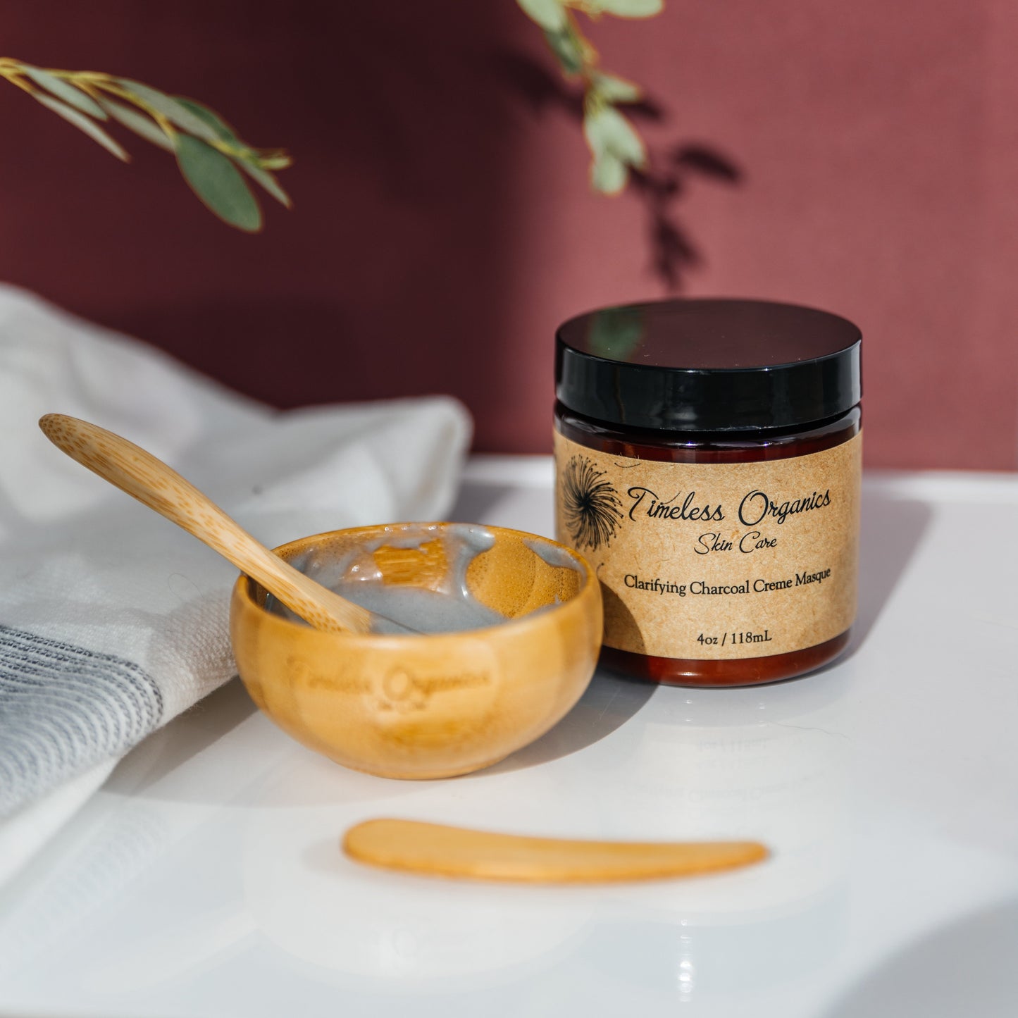 Bamboo Utensil Set for mask mixing with Timeless Organics jar and eco-friendly bamboo spoon on a spa-like setting.