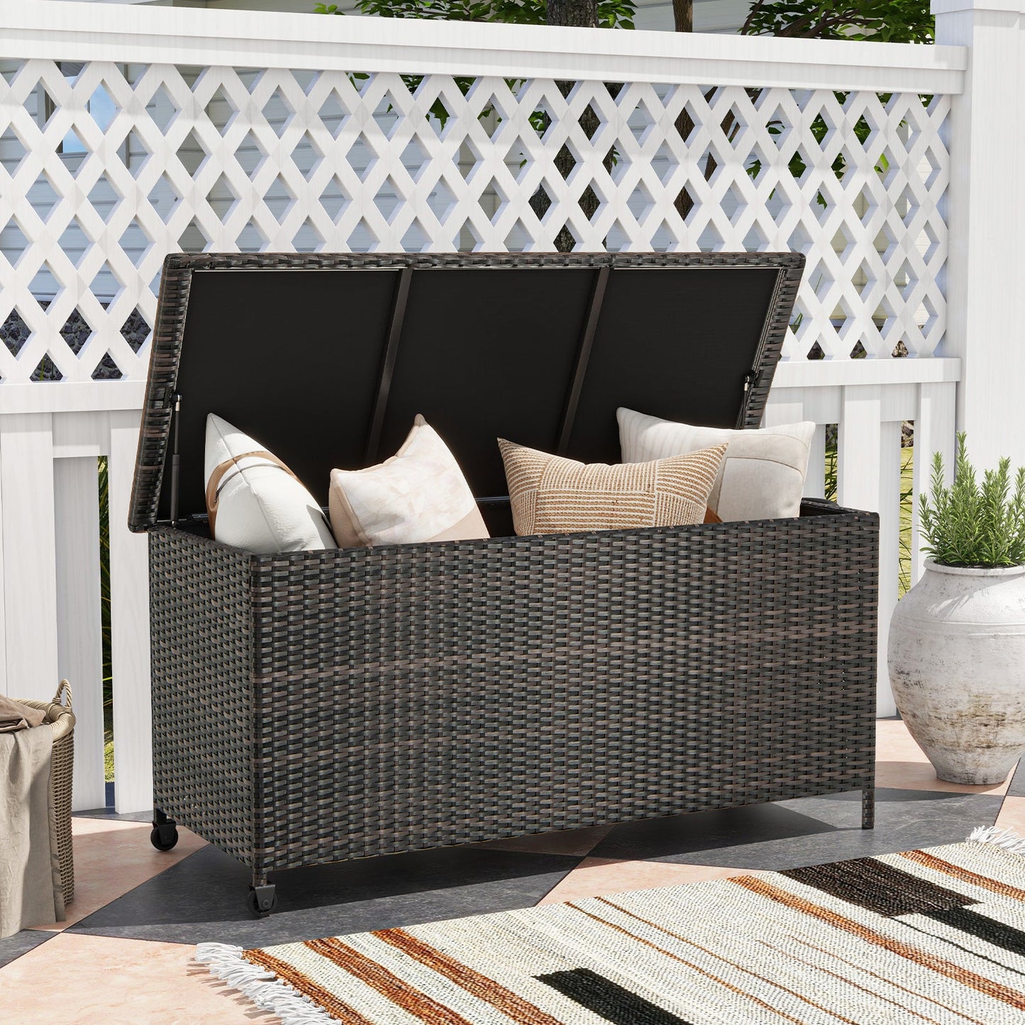 Indoor Outdoor 85 Gallon Storage Container with Waterproof Liner and Universal Wheels-Brown on patio with cushions inside