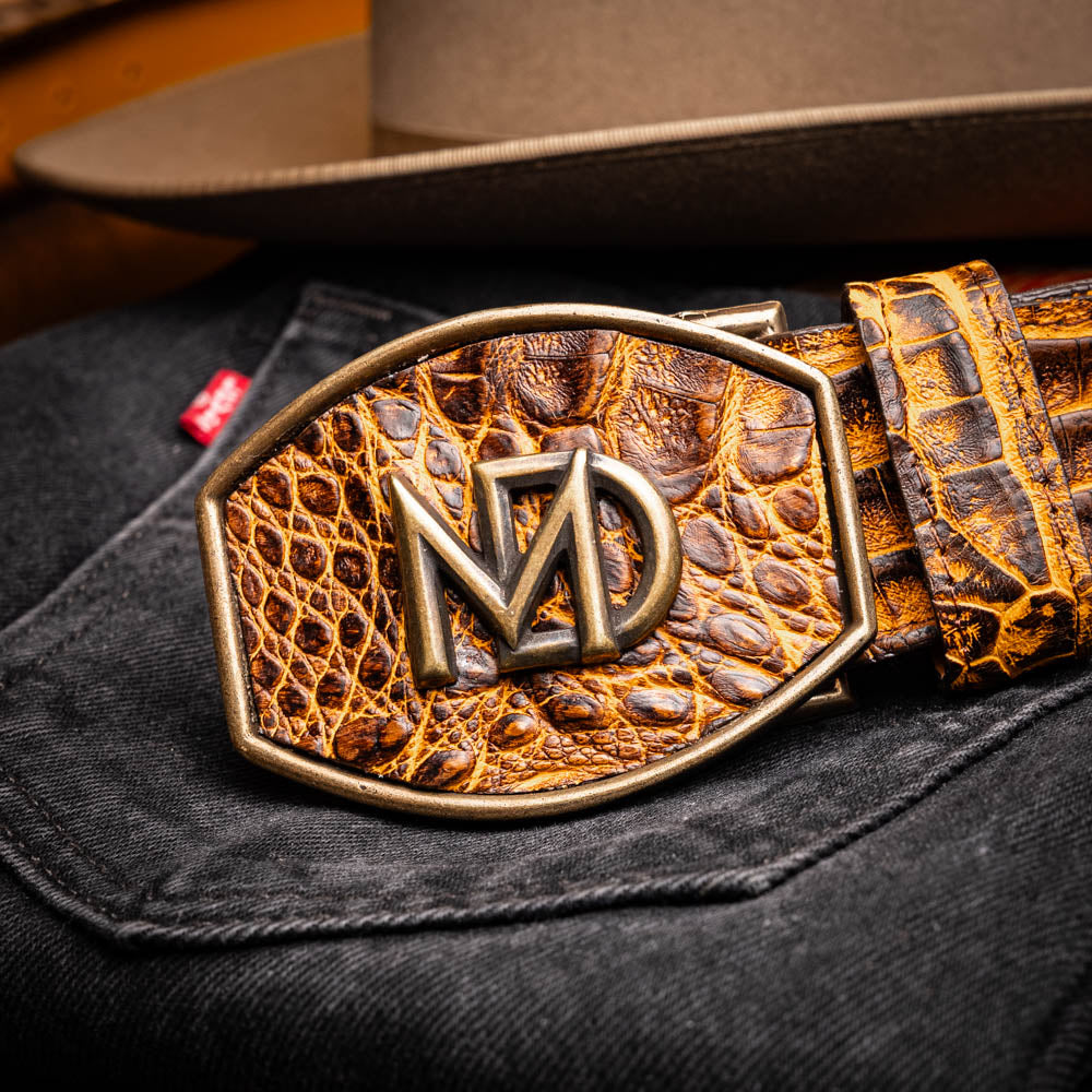 Iowa Belt Mustard Brown handcrafted caiman skin with antique brass buckle on black denim and hat