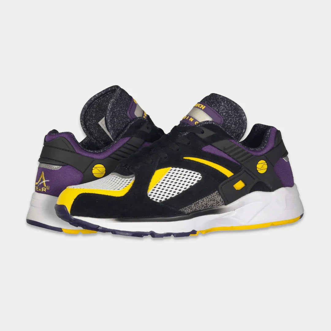 LA Gear Men's Catapult Light-Up Lowtop in black, purple, and yellow with iconic 90s design and genuine leather finish.