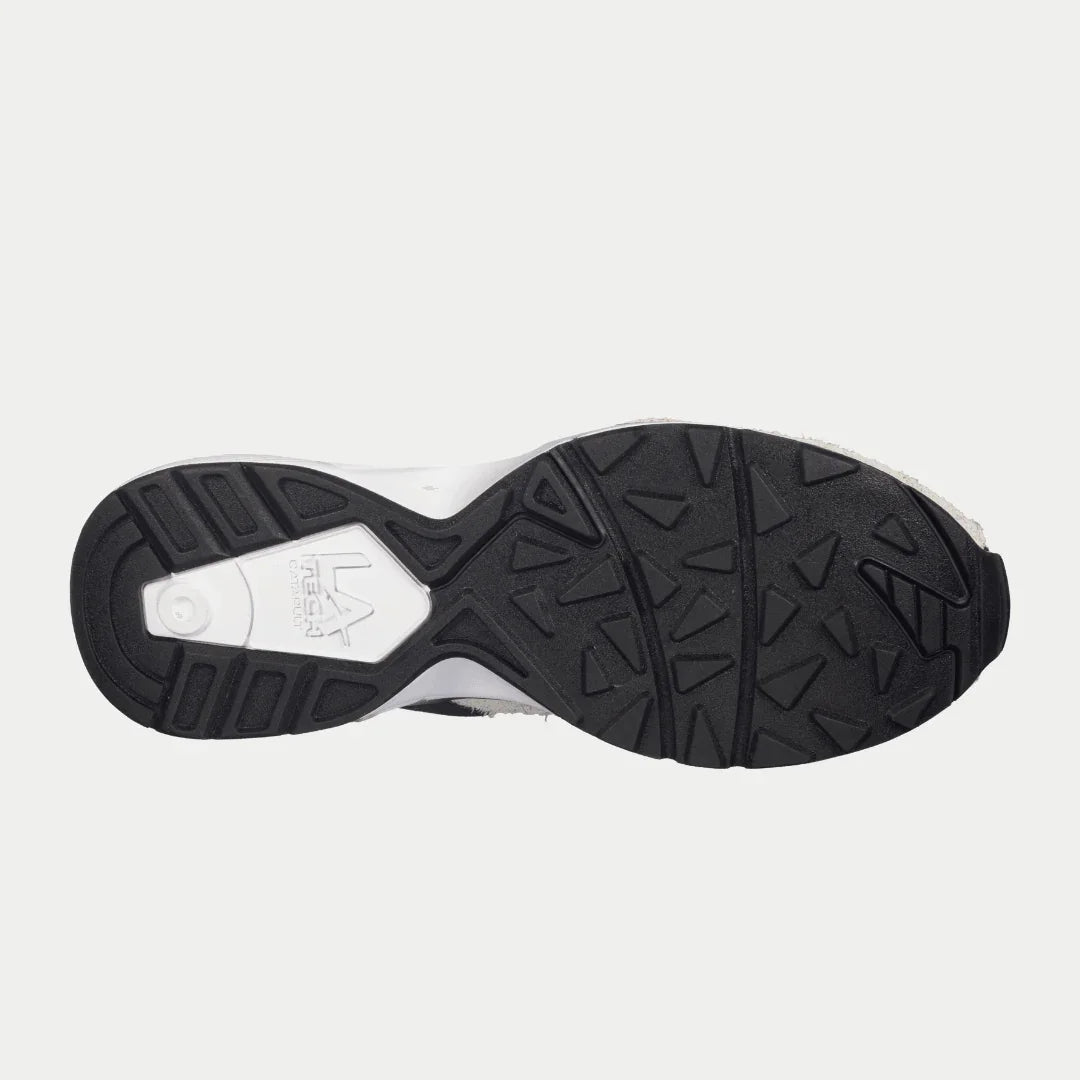 Bottom sole view of LA Gear Women's Catapult Light-up Lowtop | White x Black sneaker, showing tread pattern and logo detail.