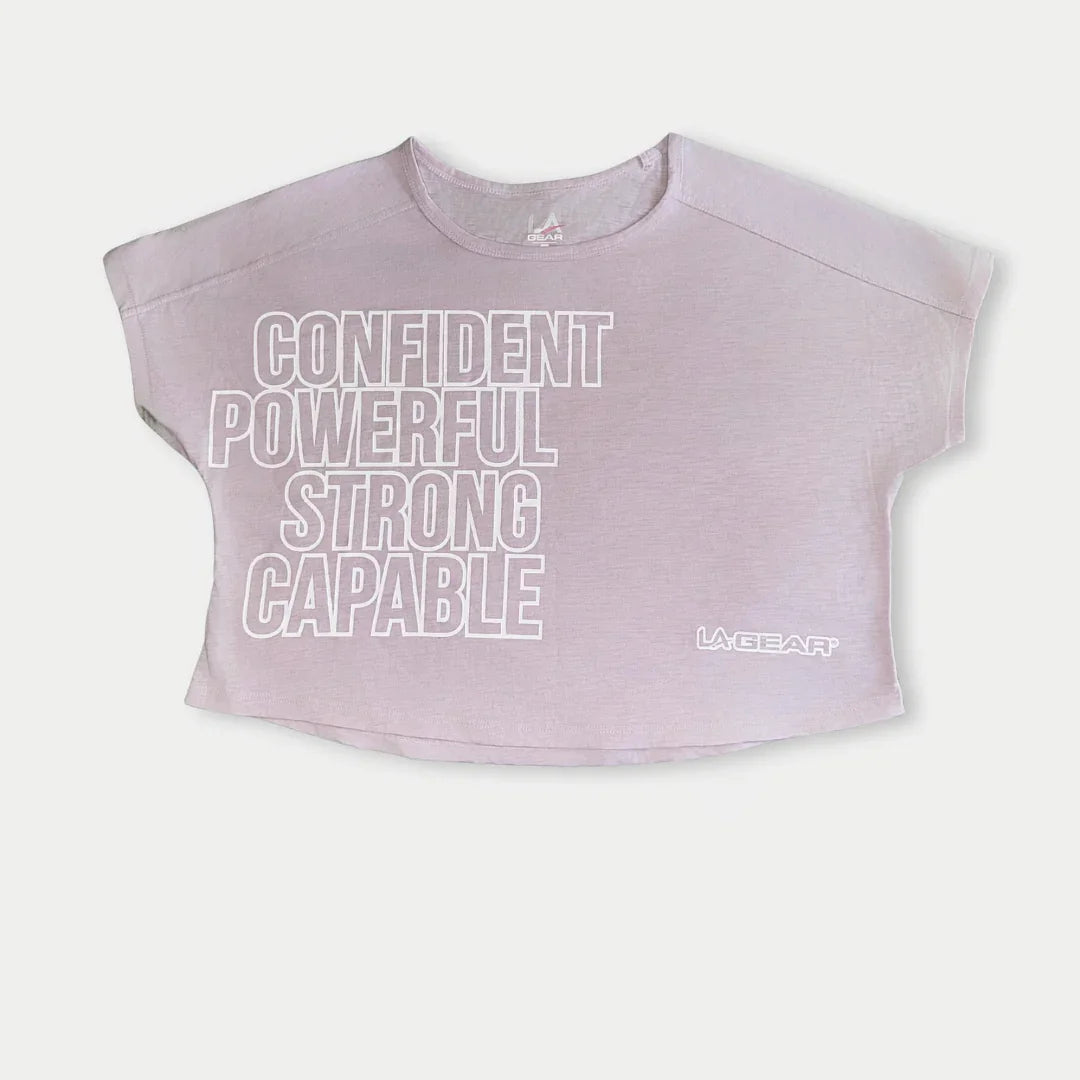 LA Gear Women’s Cropped Logo Tee | Lavender-Pink with bold text: Confident, Powerful, Strong, Capable.