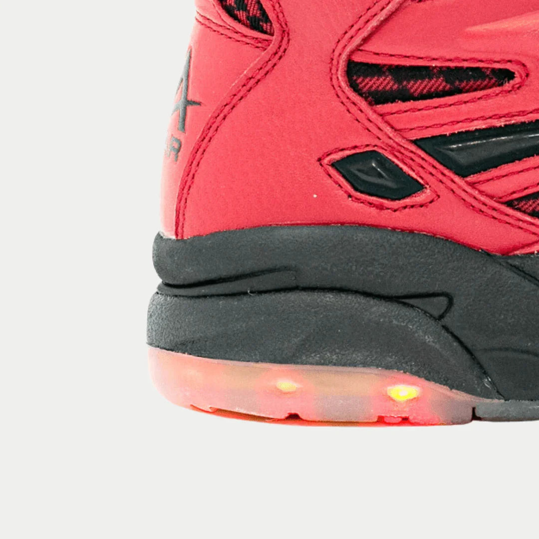 Close-up of LA Gear Women's LA Tech Light-Up Hightop showing black and red suede design with light-up heel from 90s vintage collection.