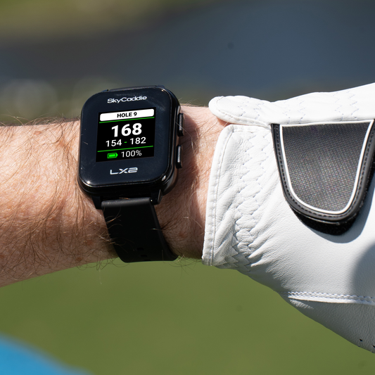 Golfer wearing SkyCaddie® LX2 watch with sunlight-readable display, no annual fees with PAR plan.