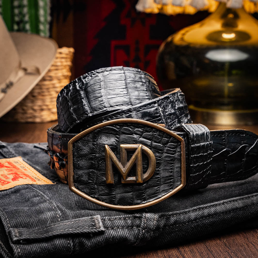 Marlboro Belt Black - Genuine hornback caiman crocodile leather with antique brass buckle on jeans, showcasing luxury design.