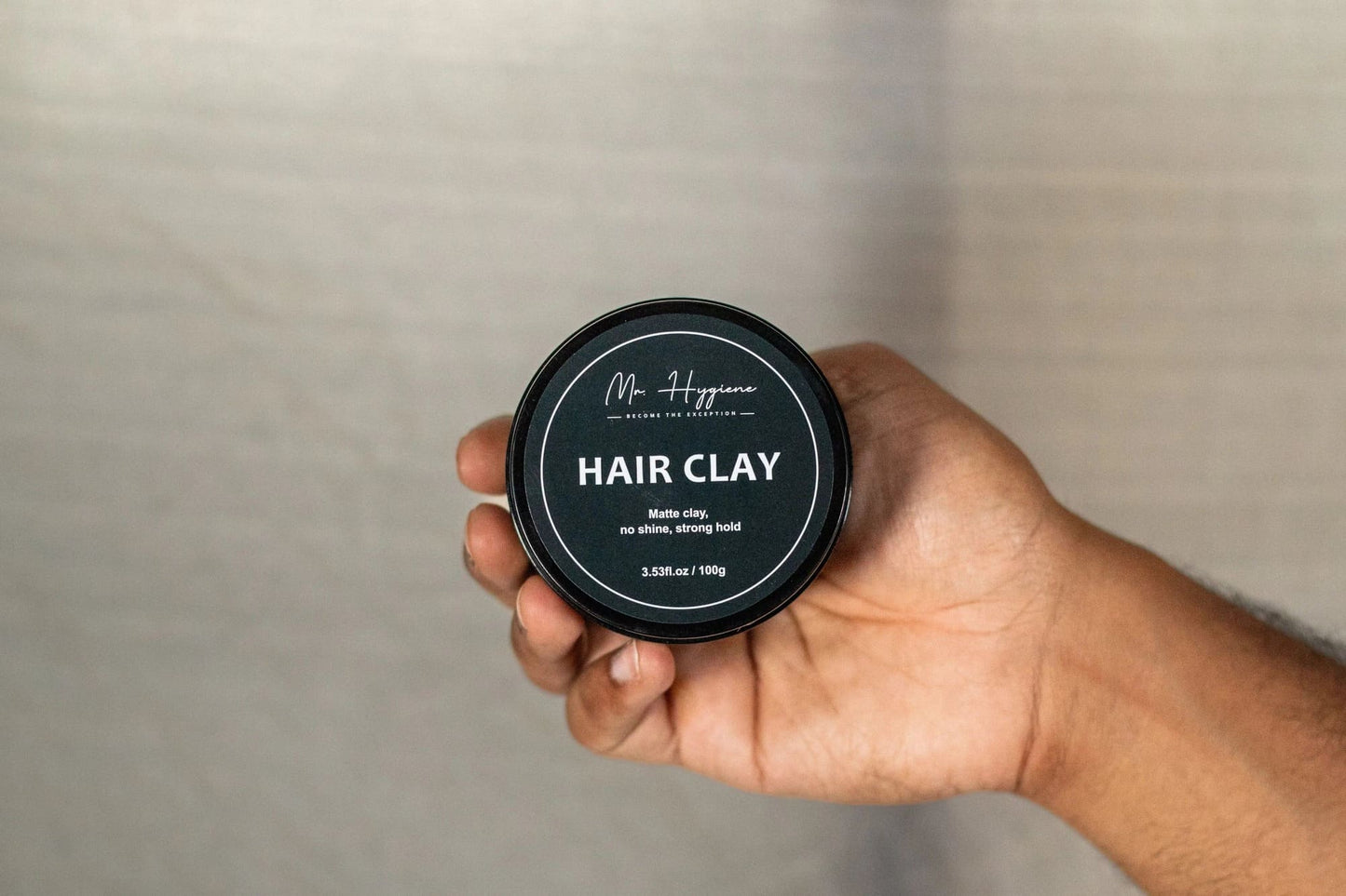 Person holding Matte Finish Hair Clay - Strong Hold. Zero Shine. All-Day Control.