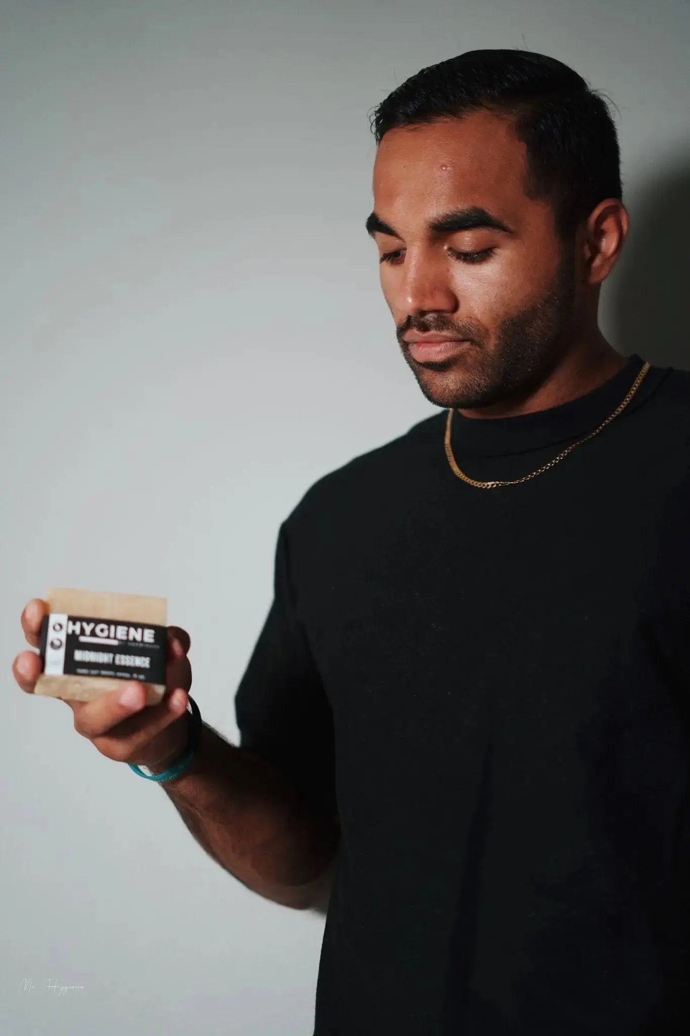 Man holding Midnight Essence Bar Soap – Bold Scent, Deep Clean.