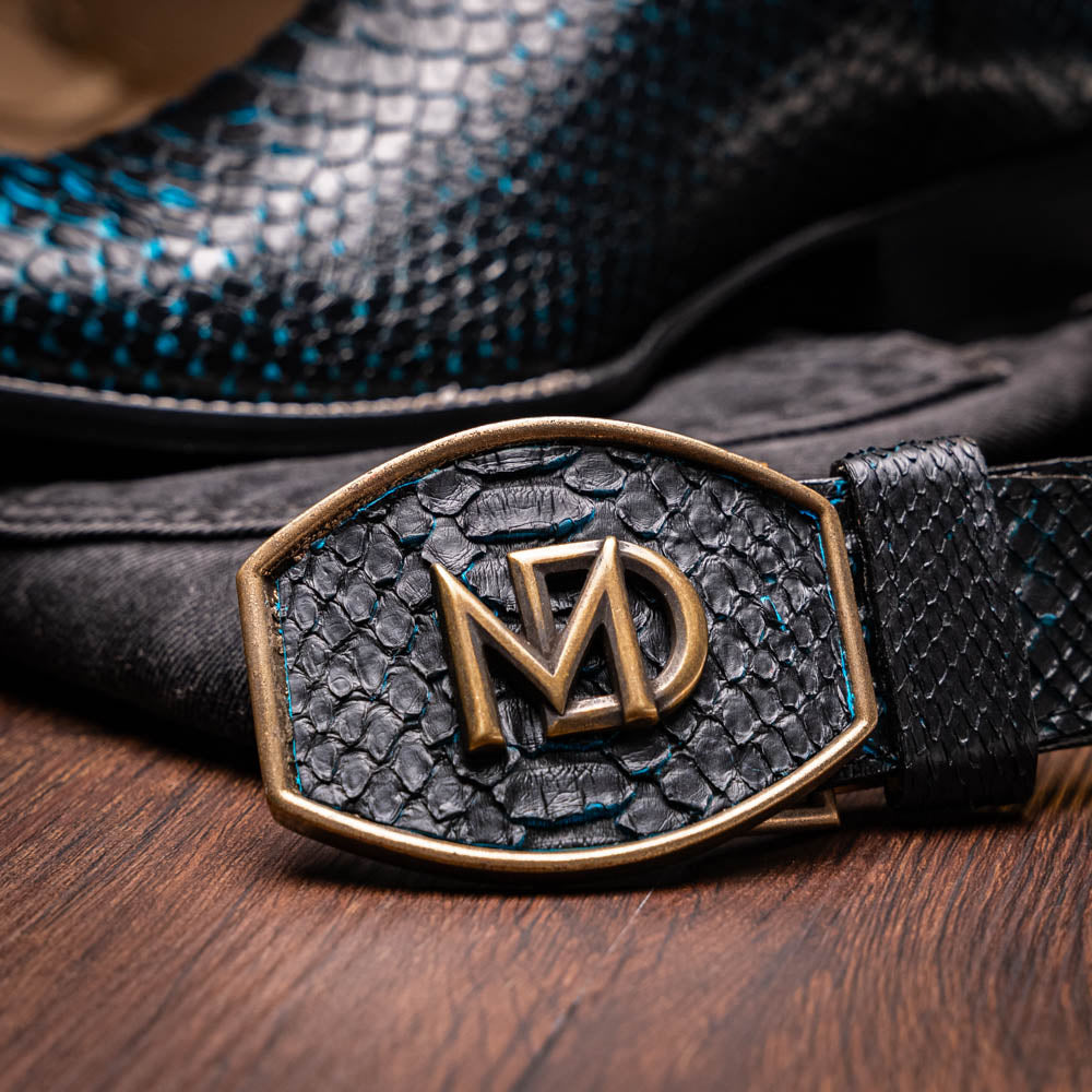 Close-up of Missouri Black / Blue Python skin cowboy boot with MD logo buckle, showcasing premium craftsmanship and exotic materials.