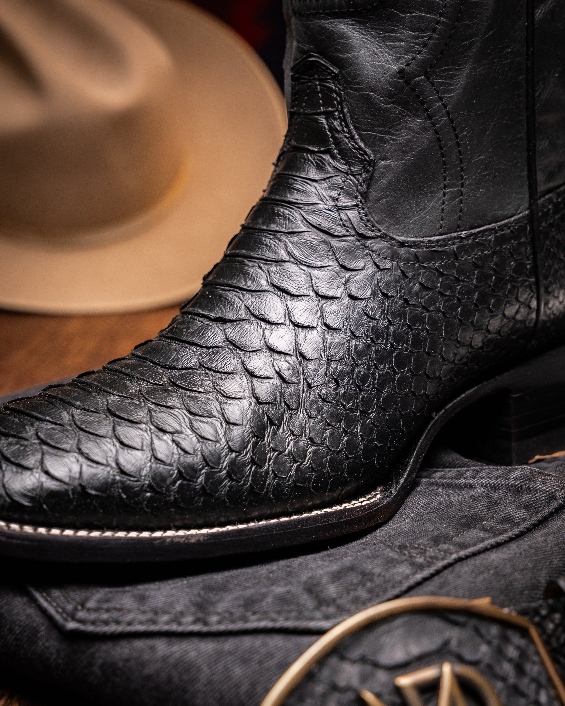 Missouri Black python skin cowboy boot with square toe design on textured surface