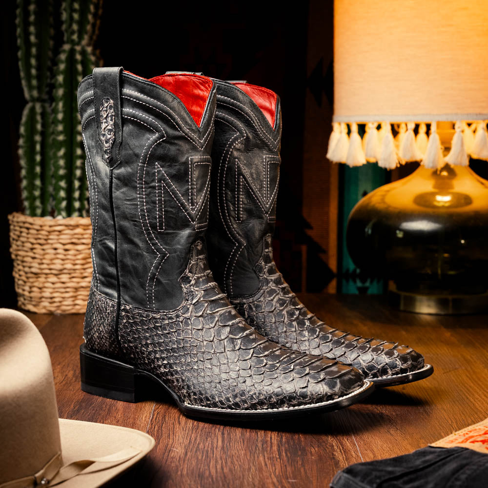 Missouri Stone White genuine Python skin cowboy boots on wooden table in a western-themed setting