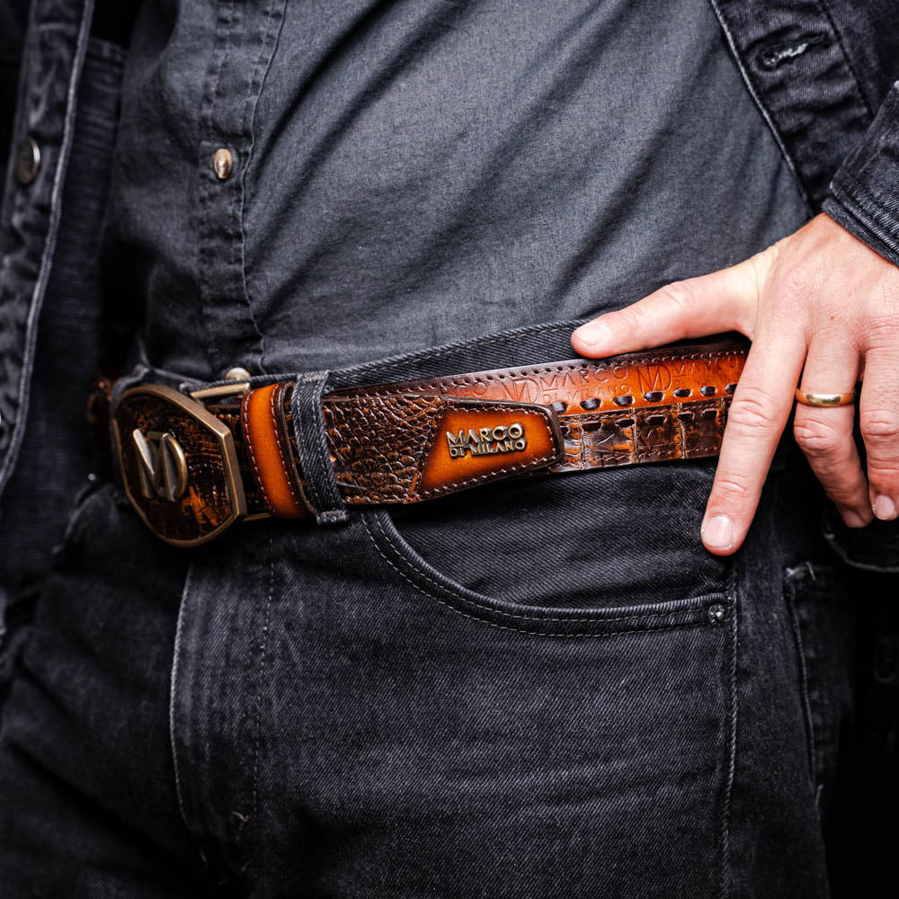 Man wearing Montana Belt Aged Brown made of caiman and calfskin with hand-stitched detail and Marco Di Milano branding.