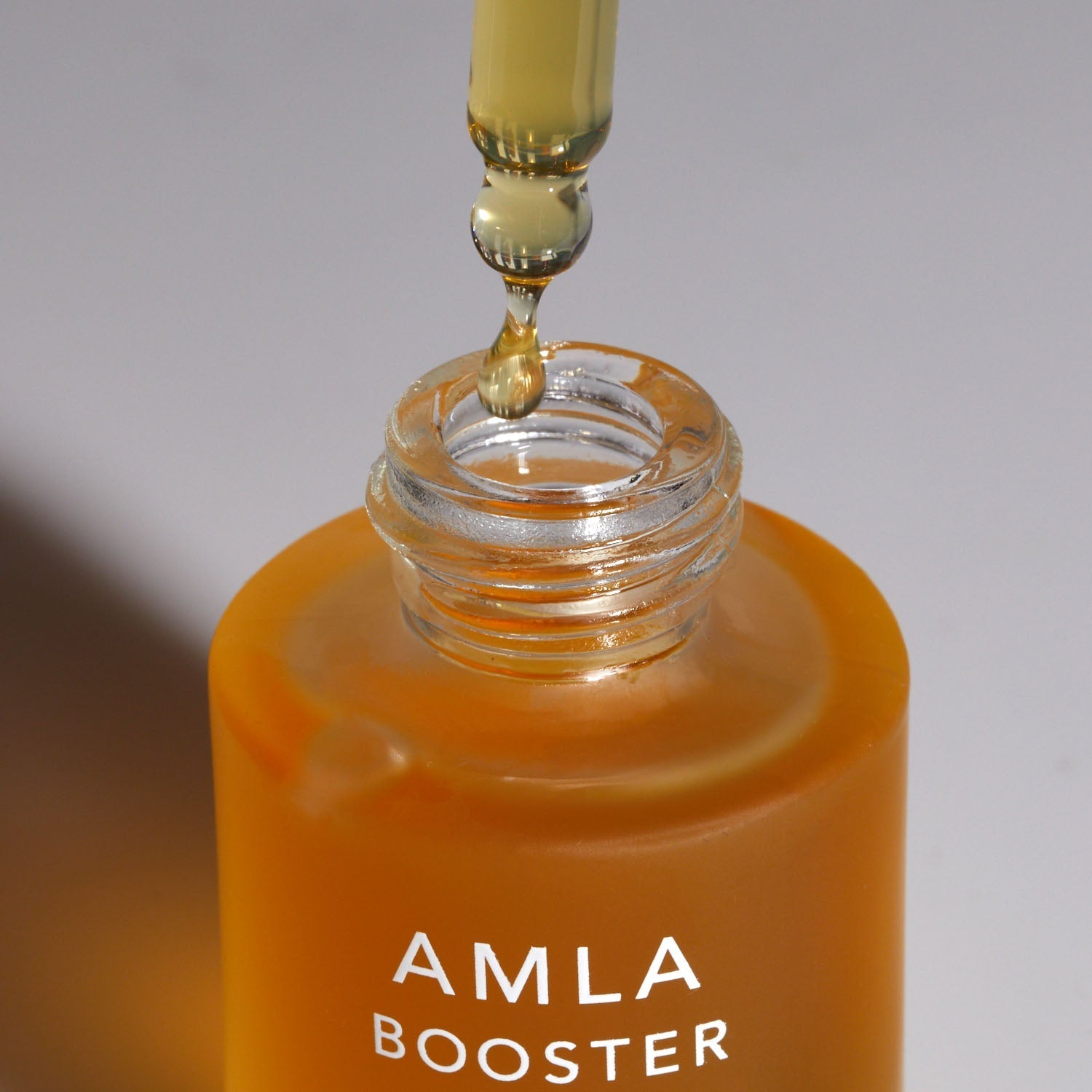 AMLA OIL bottle with dropper, showcasing booster oil's rich antioxidant benefits for skin and hair care.