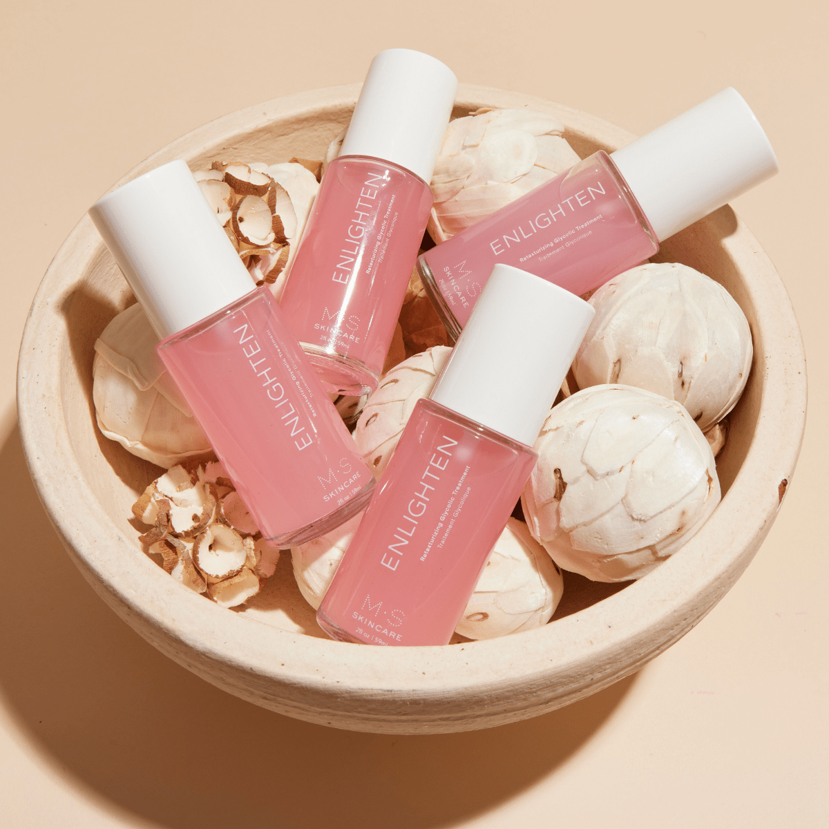 ENLIGHTEN skincare treatment with glycolic acid, red seaweed, hibiscus, rose, and aloe for improved skin texture and brightening.