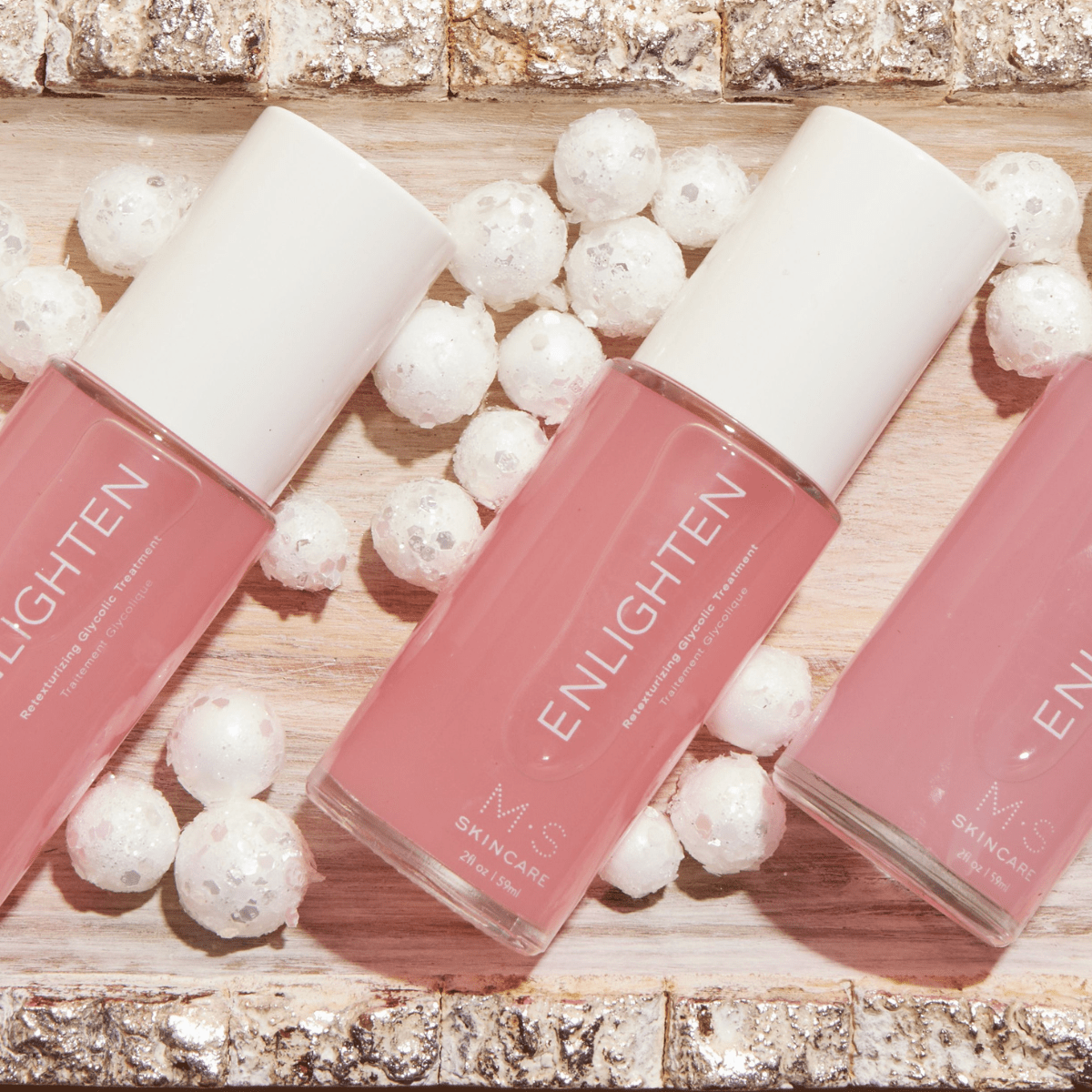 ENLIGHTEN skincare treatment with glycolic acid, red seaweed, and hibiscus for re-texturizing and brightening skin.