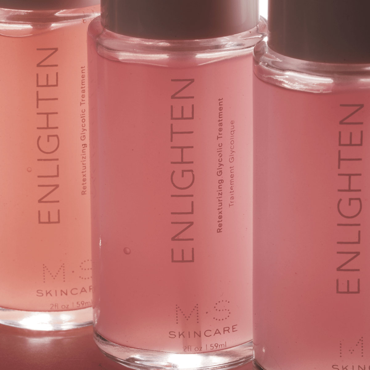 ENLIGHTEN re-texturizing glycolic treatment with antioxidant-rich red seaweed and hibiscus in clear bottles for smoother skin.