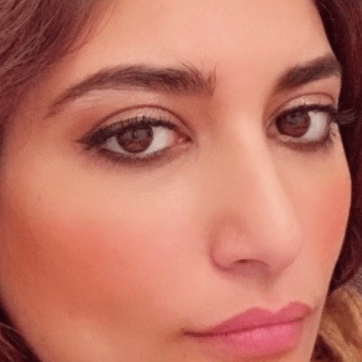 Close-up of woman's well-groomed eyebrows achieved with HIGHBROW treatment, showcasing thick and healthy brow appearance.