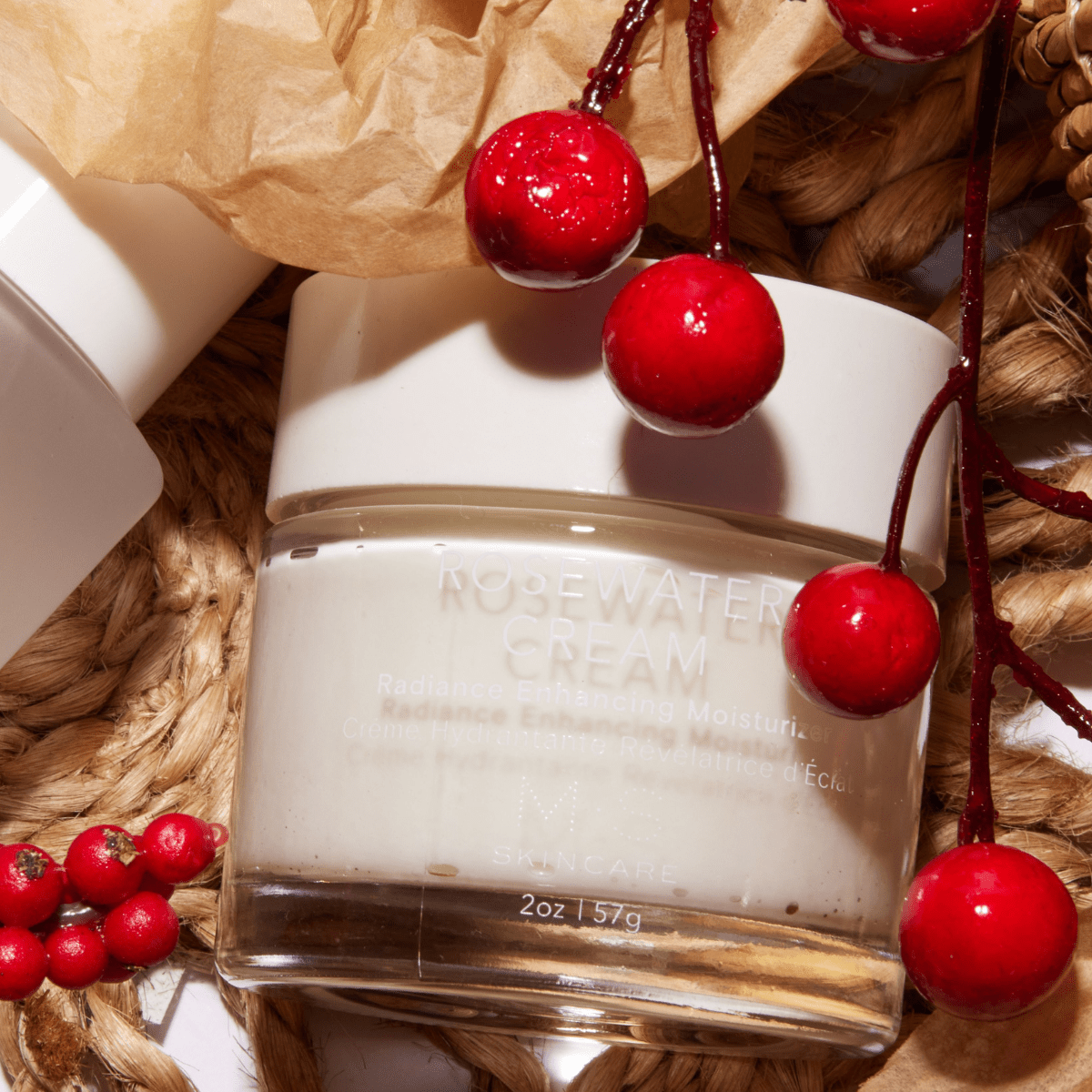 ROSEWATER CREAM jar surrounded by red berries and natural packaging, showcasing premium skincare ingredients.