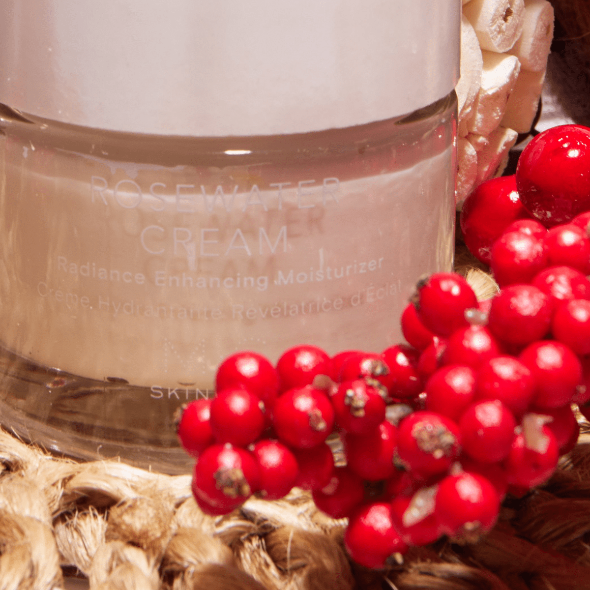 ROSEWATER CREAM jar with brightening herbal extracts and Ayurvedic oils for skin radiance and natural glow, surrounded by red berries.