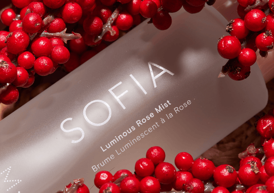 SOFIA rose mist bottle surrounded by red berries in the rose valley