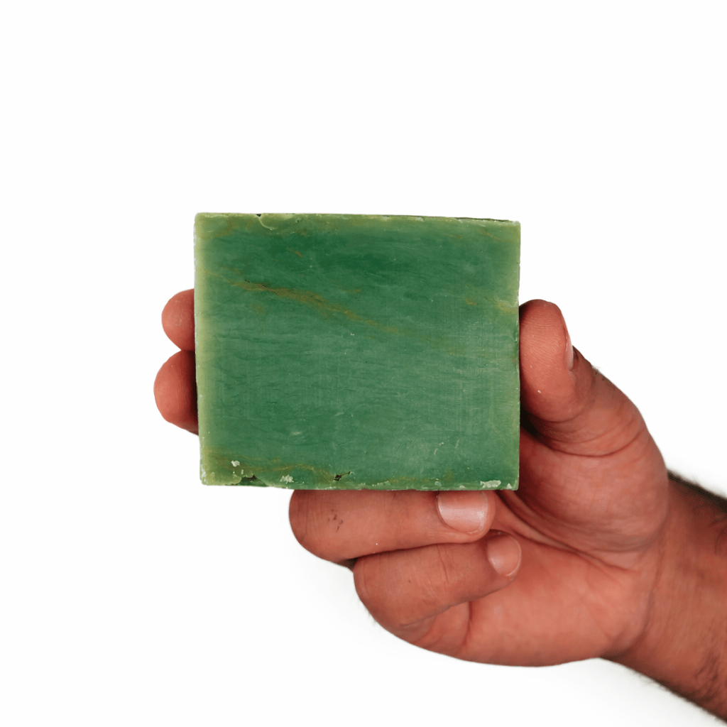 Hand holding Nature’s Breeze Bar Soap for deep cleansing and hydration