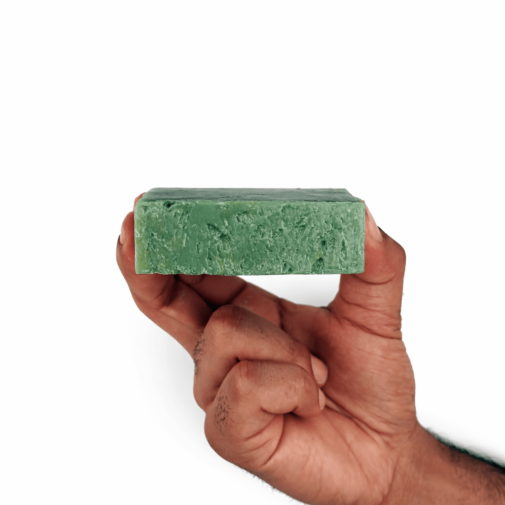 Person holding a green Nature’s Breeze Bar Soap for deep cleansing and hydration