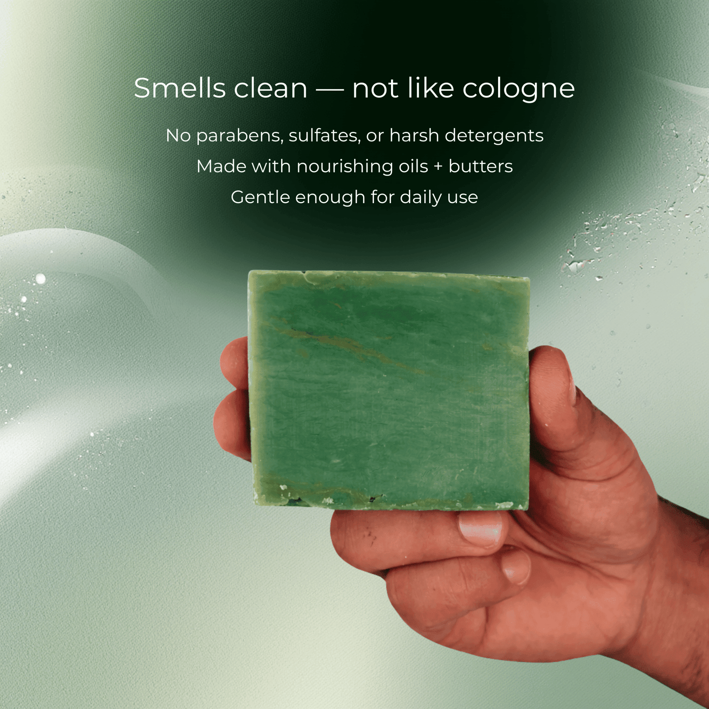 Hand holding Nature’s Breeze Bar Soap with natural ingredients for men, showcasing a green soap bar against a green background