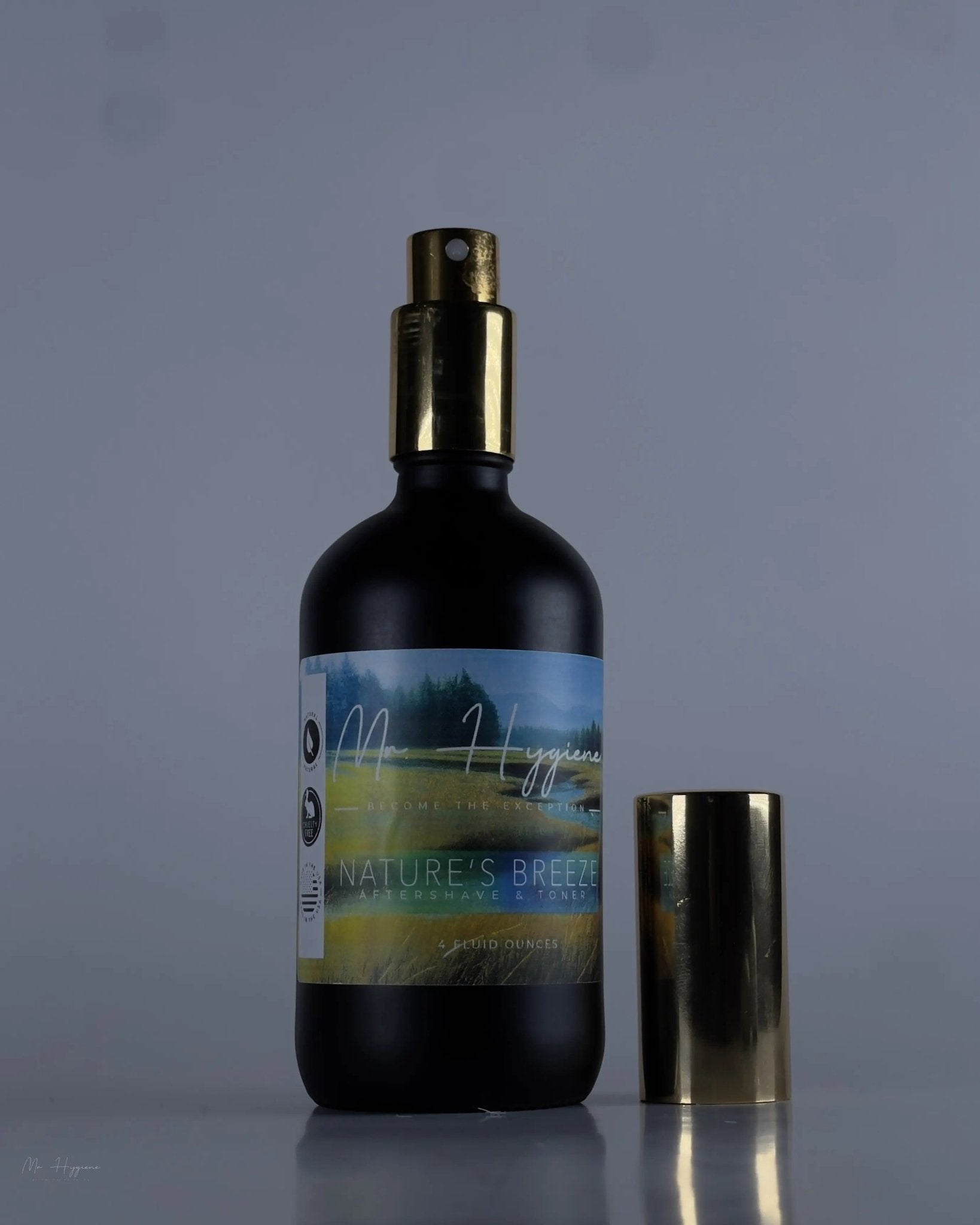 Nature's Breeze All Natural Aftershave in sleek black bottle with gold spray cap, ideal for soothing and hydrating post-shave skin.