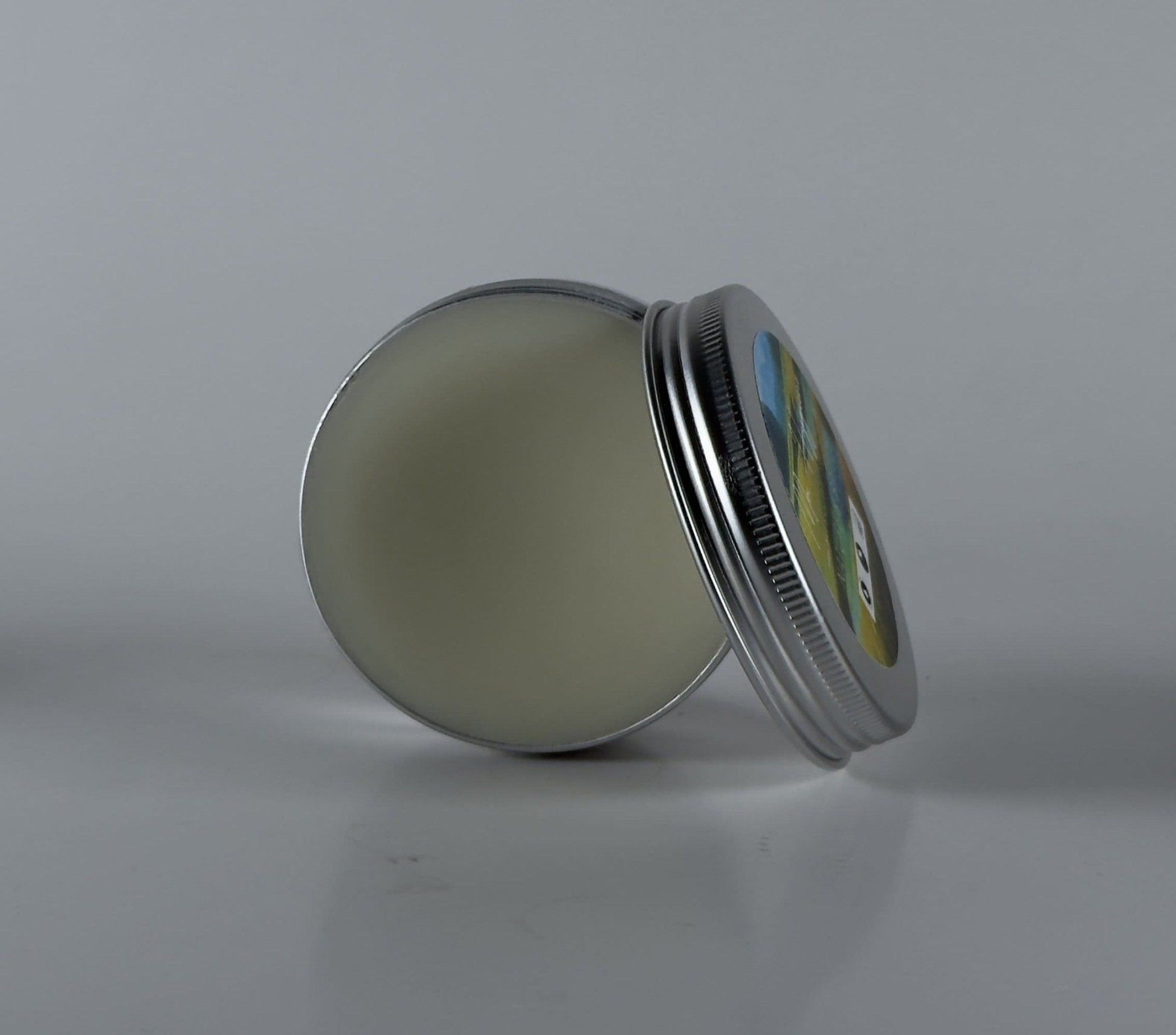 Nature's Breeze Organic Beard Balm in a metal tin for hydration and control