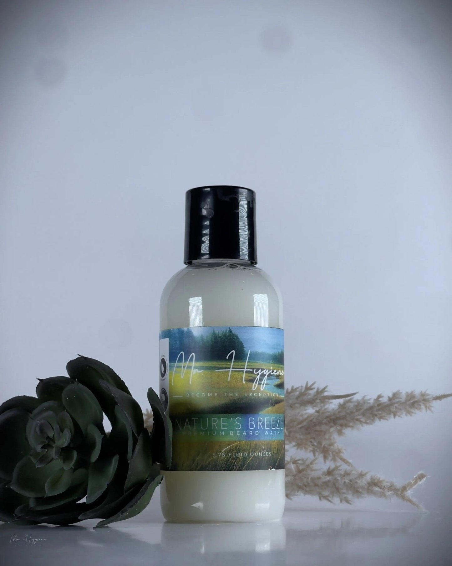 Bottle of Nature's Breeze Organic Beard Wash with decorative plant elements, showcasing premium grooming product.