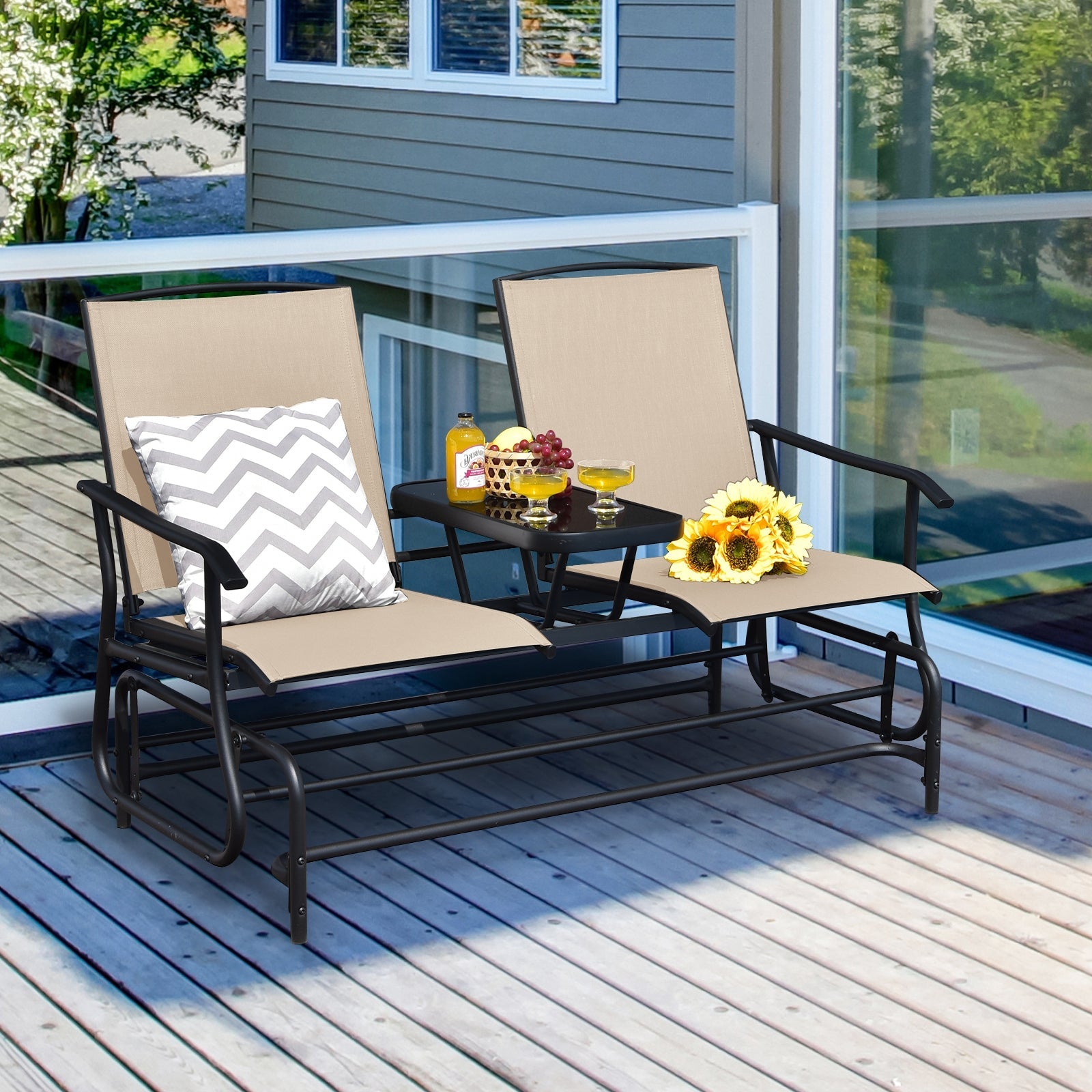 2-Person Rocking Loveseat with Mesh Fabric and Tempered Glass Table on patio with sunflowers and drinks displayed