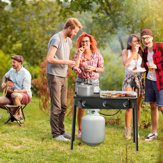 Outdoor gathering using 225000 BTU Portable Propane 3 Burner Gas Cooker for tailgating, highlighting its sturdy design and cooking ability.