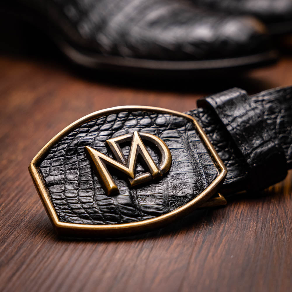 Black leather belt with gold emblem, complements Phoenix Black boots