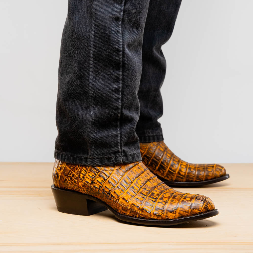 Phoenix Mustard Brown cowboy boots made from genuine caiman belly skin, showcasing Western style and texture.
