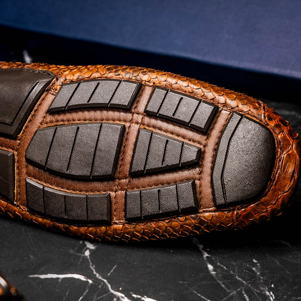 Pia Cognac shoe sole displaying genuine python skin texture and luxury design.