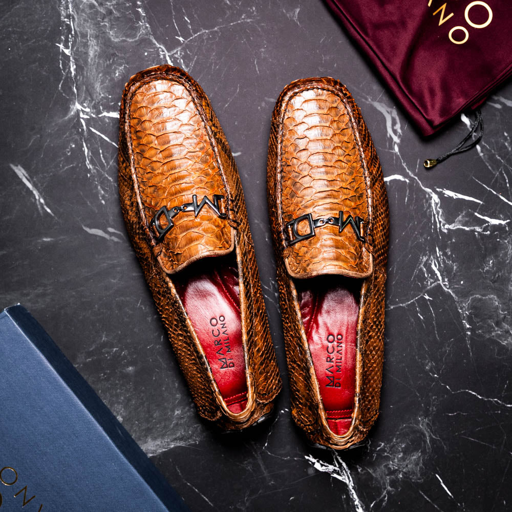 Pia Cognac python skin driver shoe with luxury texture and timeless elegance on marble background.