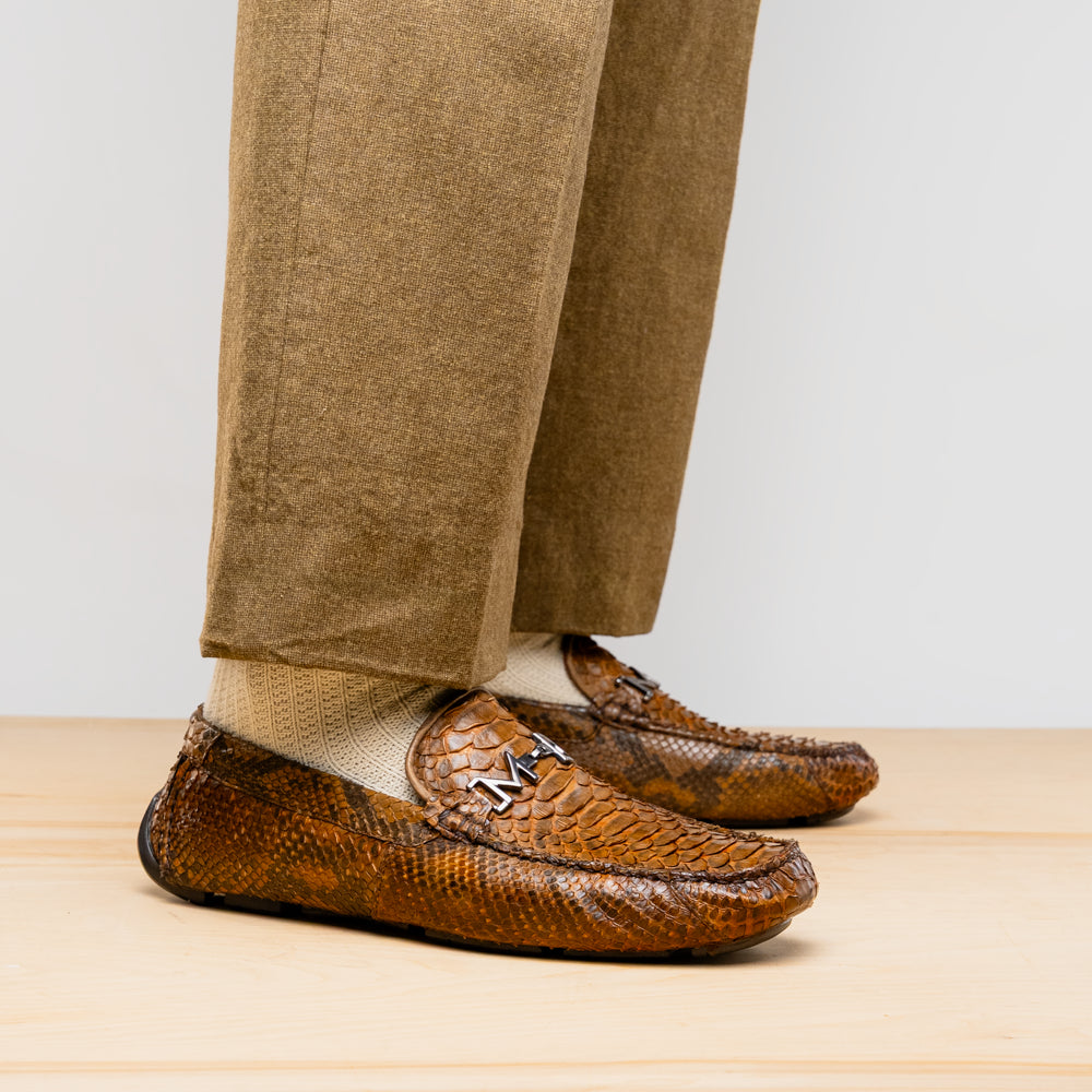 Man wearing Pia Cognac python skin driver shoe with textured elegance.