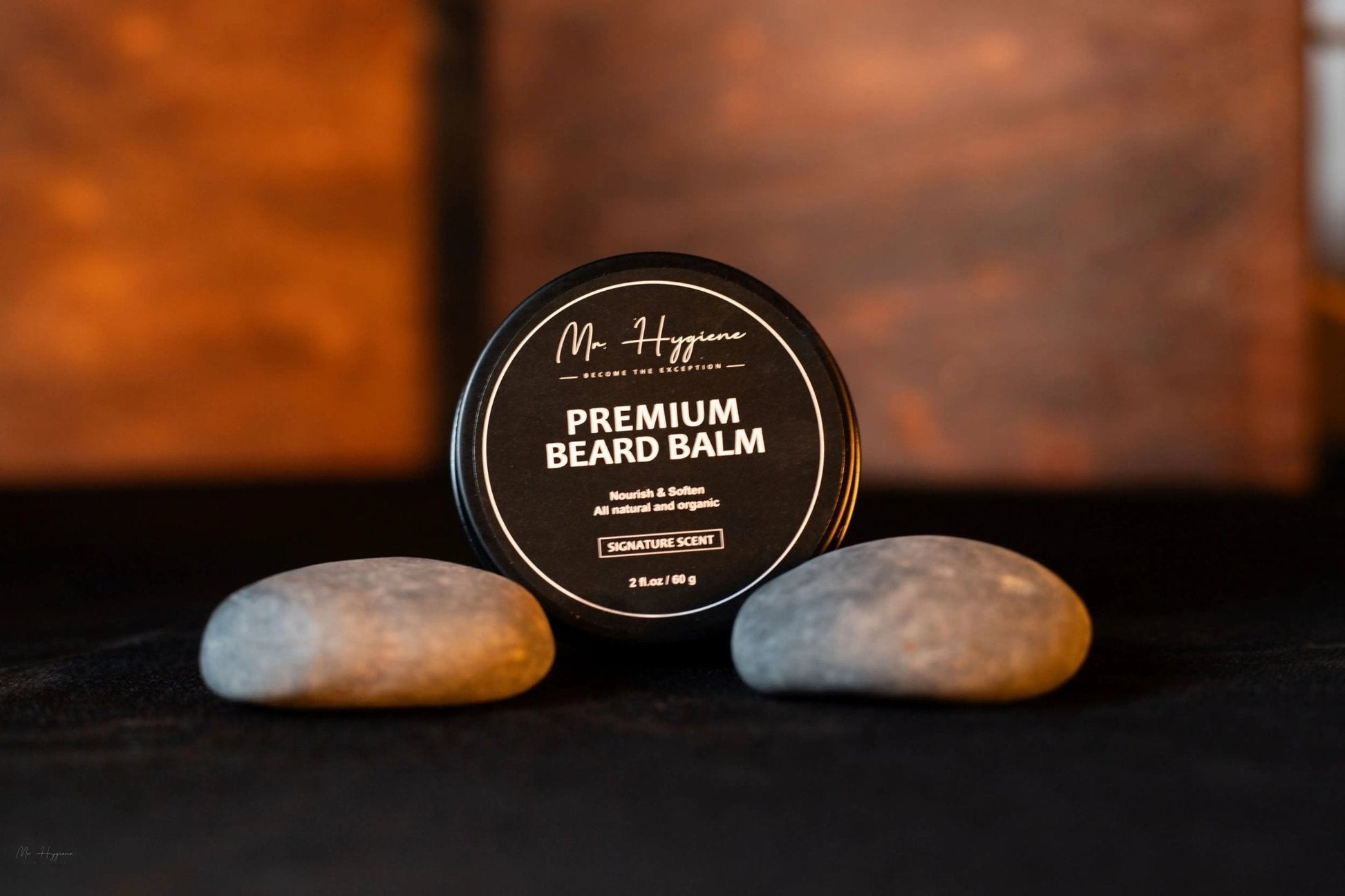 Mr. Hygiene Premium Beard Oil and Balm Set displayed with rocks for luxurious beard care.