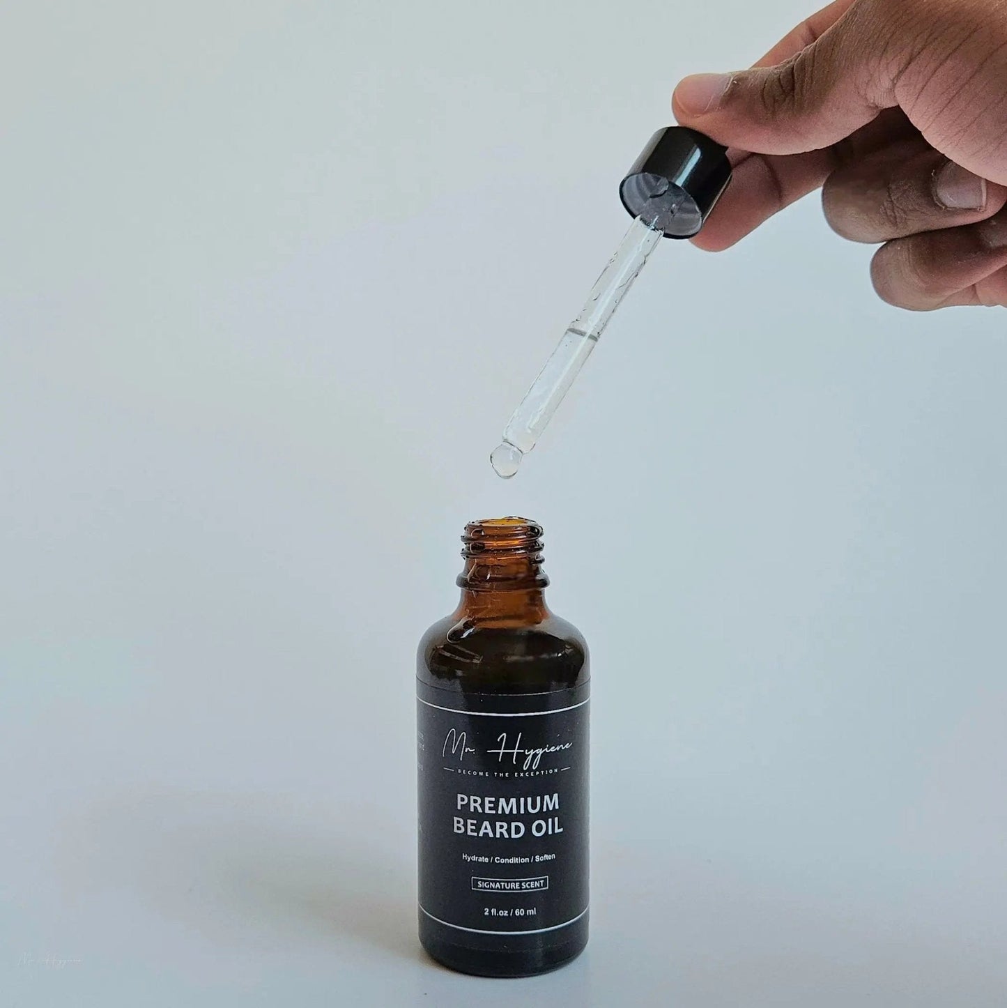 Bottle of Premium Beard Oil with dropper for nourishing and grooming men's beards.