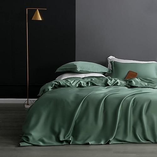 Karen Solid Color Lyocell Duvet Cover Set in a modern, boho style bedroom with green Tencel Lyocell bedding and decor.