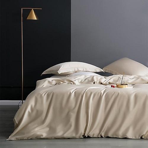 Karen Solid Color Lyocell Duvet Cover Set in neutral shade, showcasing sleek modern design with soft fabric, styled in a bedroom setting.